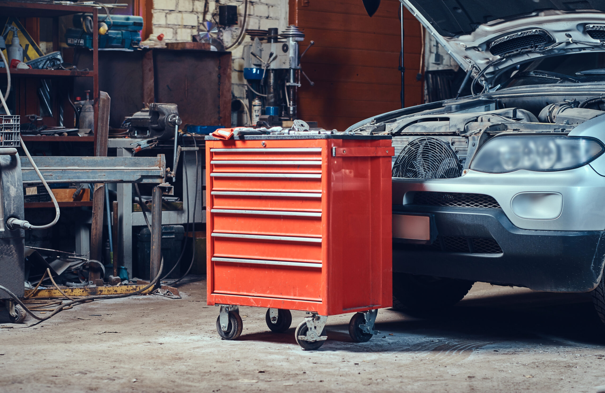 Red steel tool box in a garage.